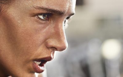 Cropped shot of a determined looking young woman working out in the gym